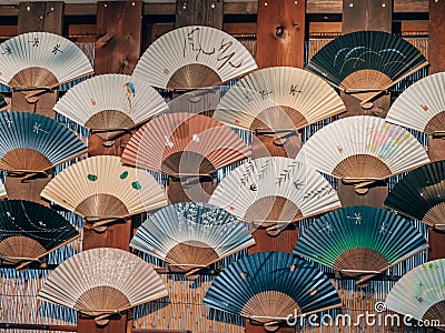 Collection of beautiful Japanese fans hung on a wall Editorial Stock Photo