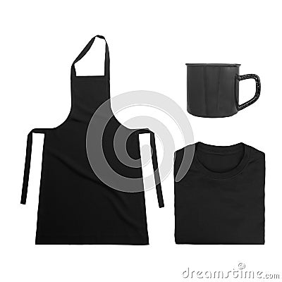 Collection of black objects isolated on white background. Black blank apron, black folded t-shirt, metal mug. Flat lay Stock Photo