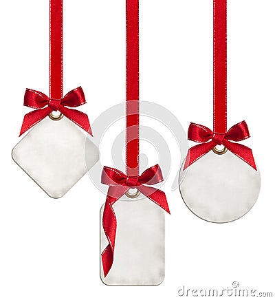 Collection of blank gift tags tied with red satin ribbon bows Stock Photo