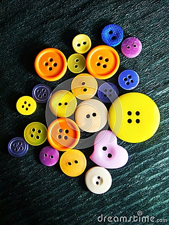 Big and small color buttons on black Stock Photo