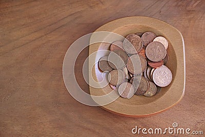 Collection coins copper pence savings in wooden bowl Stock Photo