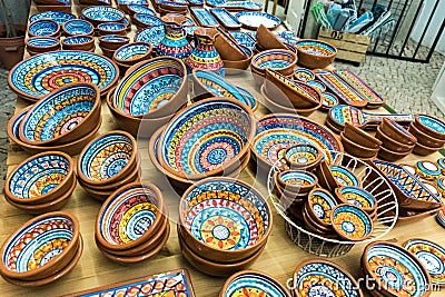 Collection of colorful pottery from a local craft store on display. Handmade ceramic gift shop in Lisbon, Portugal Stock Photo