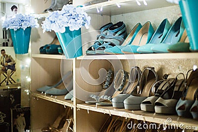 Collection of colourful shoes on shelves in interior. Stock Photo