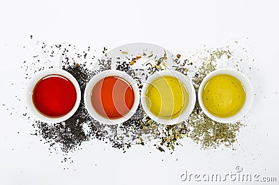 Collection of different teas in cups with tea leaves on a white background Stock Photo