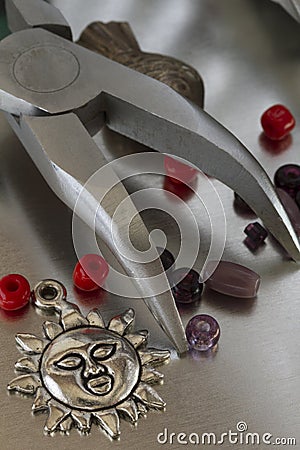 Collection of fashion jewelry items and forceps Stock Photo