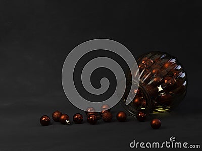 Red baubles spilling from a gold glass jar Stock Photo