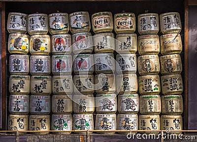 A collection of Japanese sake barrels stacked in shrine Editorial Stock Photo