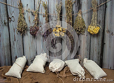 Collection, a mixture of various dried herbs in bundles and bags on a wooden background. Stock Photo