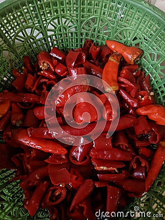 A collection of red chili pieces in a plastic baskets container Stock Photo