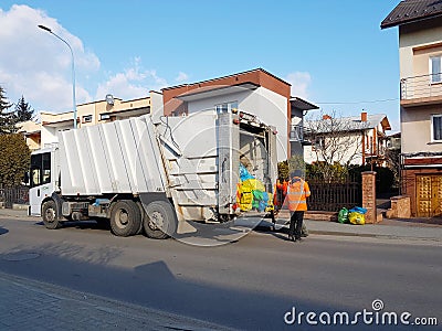 Collection and removal of household waste to service staff. Monitoring the environmental situation in cities. Recycling human Editorial Stock Photo