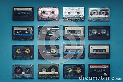 Collection Of Retro Audio Tapes On Blue Background, Top View. Retro Technology Music Concept Stock Photo