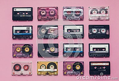 Collection Of Retro Audio Tapes In Row On Lilac Background. Retro Technology Music Concept Stock Photo