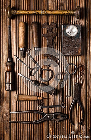 Collection of rusty tools in vintage style on wooden background Stock Photo