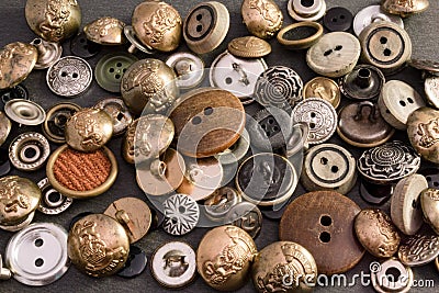 Collection of vintage clothing buttons. Dark stone background, grunge photo. Stock Photo