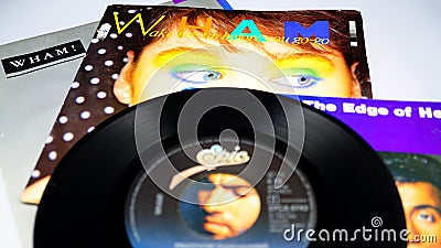 Collection of vinyl by the English duo, WHAM. first group of pop star GEORGE MICHAEL. White background Editorial Stock Photo