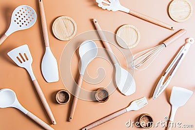 A collection of white silicone tools for cooking food in the kitchen. top view. flat styling. beige background Stock Photo