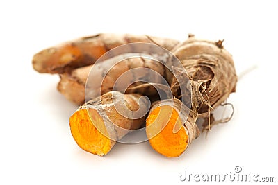 Collection of whole and sliced fresh Organic Long Turmeric (Curcuma longa). Stock Photo