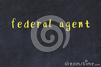 College chalk desk with the word federal agent written on in Stock Photo