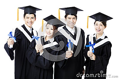 College graduates in graduation gowns standing and smiling Stock Photo