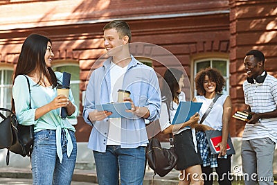 College Life. Joyful Students Chatting Outdoors During Break In Classes Stock Photo