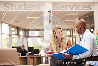 College Student Having Meeting With Tutor To Discuss Work Stock Photo