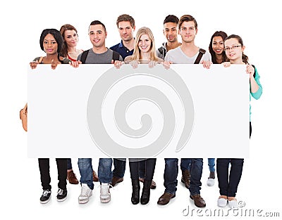 College students displaying blank billboard Stock Photo