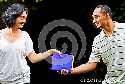 College students hand over books Stock Photo