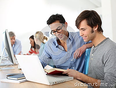 College students working with book and laptop Stock Photo