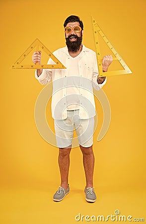 College university education. Bearded nerd with triangle. Exploring properties. Man math lesson. Student using measuring Stock Photo