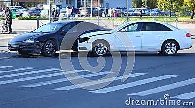 Collision of a black car and a white car at a pedestrian crossing Editorial Stock Photo