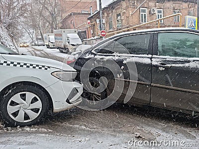 he collision of a white taxi and a black car due to ice. Editorial Stock Photo