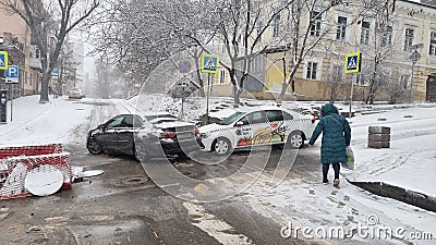 he collision of a white taxi and a black car due to ice. Editorial Stock Photo