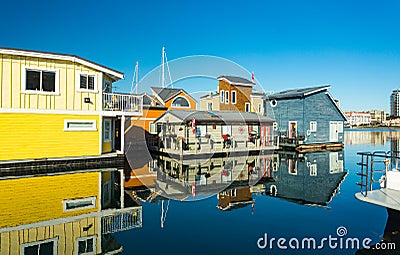 Colorful village of float homes on bright sunny day, blue sky. Stock Photo