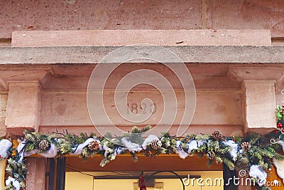 Colmar, France - December 21, 2023: Decorated facade ofof old building (1820). Old city. Christmas time Editorial Stock Photo