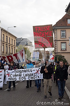 People protesting against the sanitary pass with text in french : fausse pandemic, vraie dictature, in english : false pandemic, t Editorial Stock Photo