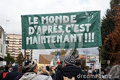 People protesting against the sanitary pass with text in french : Le monde d`aprÃ¨s, c`est maintenant, in english : the next worl Editorial Stock Photo