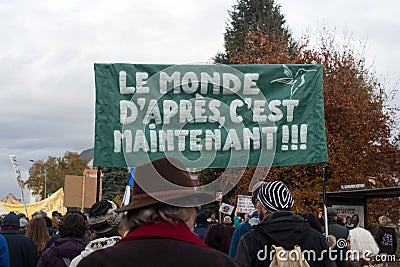 people protesting against the sanitary pass with text in french : Le monde d`aprÃ¨s, c`est maintenant, in english : the next w Editorial Stock Photo