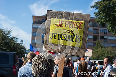 People protesting with banner in french, je pense donc je desobeis, in english : I think therefore I disobey Editorial Stock Photo