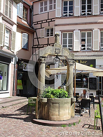 Colmar, 8th august: Old Stone Fountain from Cathedral Square in Old Town of Colmar in Alsace region , France Editorial Stock Photo