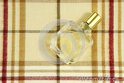 Cologne bottle on check pattern Stock Photo