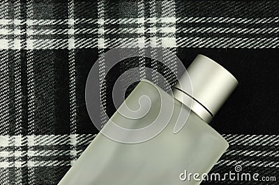 Cologne bottle on check pattern Stock Photo