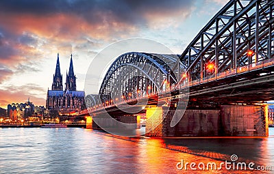 Cologne Cathedral and Hohenzollern Bridge at sunset - night Stock Photo