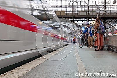 Cologne central railway station with blur background of motion of High speed train and group of passengers in Cologne, Germany. Editorial Stock Photo