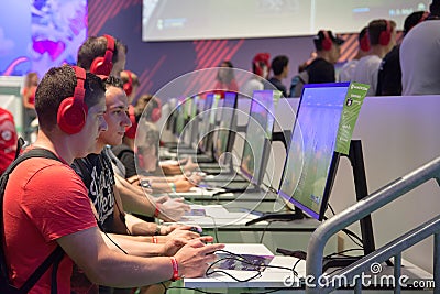 Young people at exhibition Gamescom Editorial Stock Photo