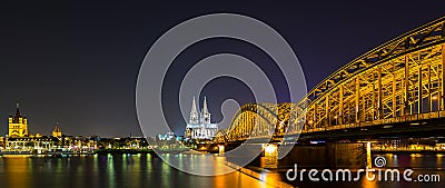 Cologne night skyline with cathedral and hohenzollern bridge Stock Photo