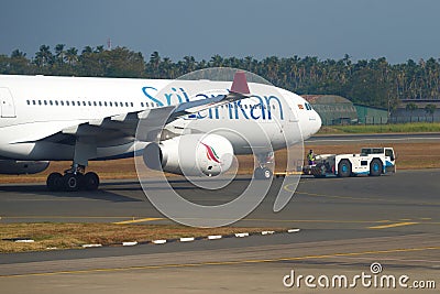 Towing an aircraft Airbus A330-300 of SriLankan Airlines Editorial Stock Photo