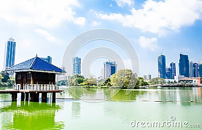 Colombo/Srilanka December 2019: VIew of Gangaramaya lake temple in Colombo Srilanka. City skyscrapersc can be seen behind Stock Photo