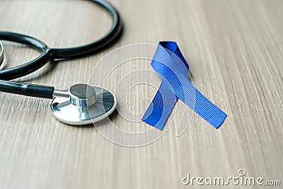 Colon Cancer Awareness, dark blue Ribbon with stethoscope for supporting people living Stock Photo