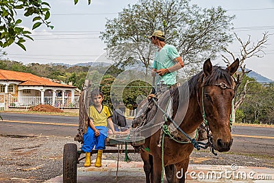 Poor indigenous family in Paraguay with uniaxial carriage and horse. Editorial Stock Photo