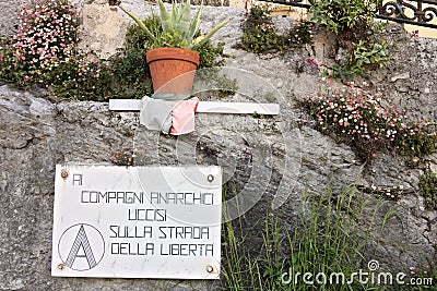 Colonnata. A plaque of the anarchist movement recalling the martyrs who died for freedom. The anarchist movement has an ancient Editorial Stock Photo